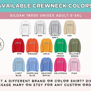 May include: A colour chart displaying fourteen Gildan 18000 crewneck sweatshirts in white, ash, sports grey, tan, red, orange, gold, irish green, military green, light blue, carolina blue, heather royal, heliconia, and pink, each featuring the text OPALITE.