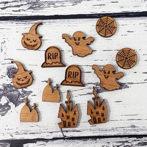May include: A set of 10 wooden Halloween-themed ornaments, including ghosts, pumpkins, tombstones, and spiderwebs. The ornaments are laser-cut and have a natural wood finish.