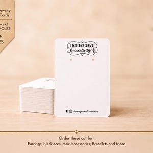 May include: A stack of rectangular white jewelry display cards featuring the black text Homegrown creativity at the top, two small holes for earrings, and social media icons with the handle HomegrownCreativity printed at the bottom edge.