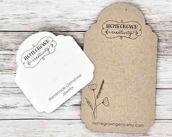 May include: Two white card stock tags with black text. The top tag has a brown background and a floral design. The text on the top tag reads "Homegrown creativity" and "homegrowngeme.etsy.com". The bottom tag has the text "Homegrown creativity" and "Handmade Gemstone Jewellery".