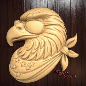May include: A wooden carving of an eagle wearing sunglasses and a bandana with stars. The eagle is facing to the left and the bandana is tied around its neck. The carving is on a dark wood background.