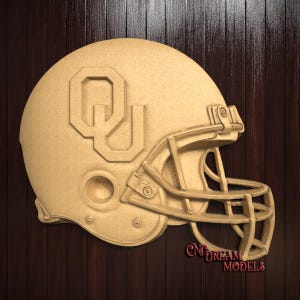 May include: A brown wooden football helmet with a white "OU" logo on the side. The helmet is in profile view and has a face mask.