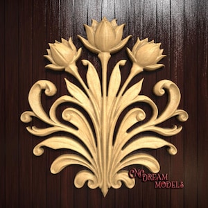 May include: A carved wooden floral design featuring three lotus flowers and stylized leaves. The design is in a light tan color and is mounted on a dark brown wooden background. The text "CNC DREAM MODELS" is visible in the lower right corner.