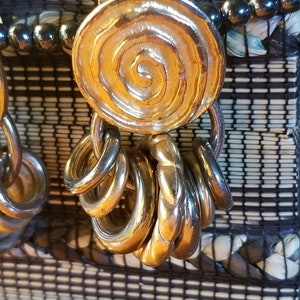 GOLD DANGLE EARRINGS 1.75" x1".  Gold Tone Oval Spiral with Lower hoop embellished with 7 gold rings. Vintage 1980s.  Stunning! Pierced ears