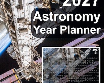 May include: A 2027 Astronomy Year Planner wall calendar featuring a high-resolution photograph of the International Space Station orbiting Earth. The calendar displays a grid layout with text and dates against a black space background.