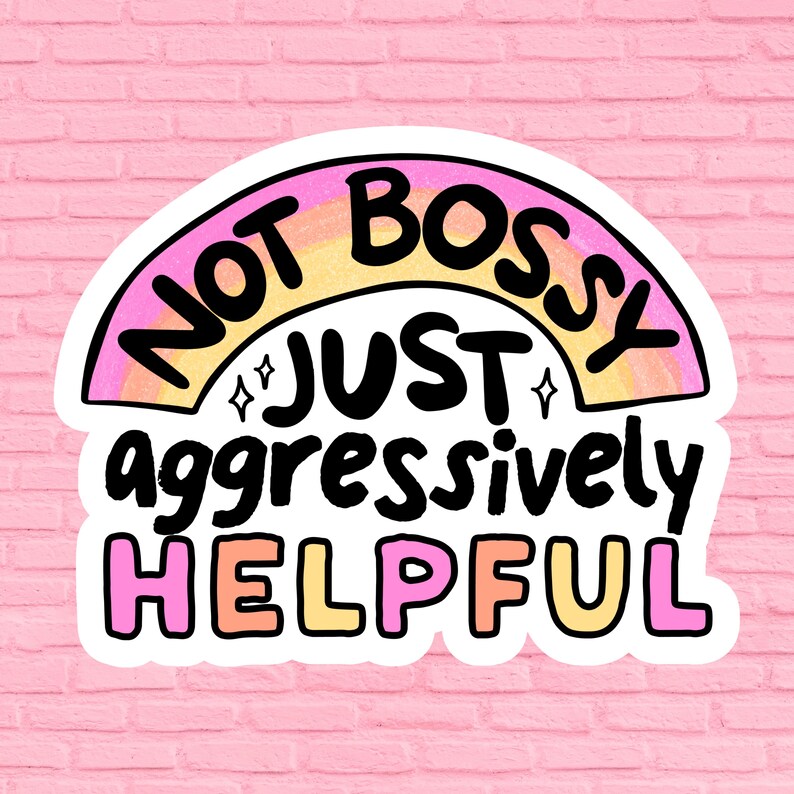 May include: A white sticker with a rainbow arc and the text "Not bossy just aggressively helpful" in black lettering.