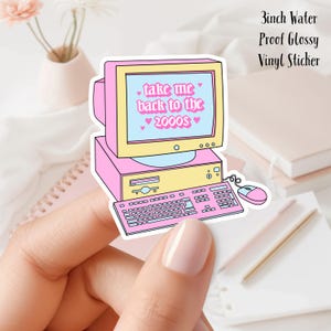May include: A 3-inch water-proof glossy vinyl sticker featuring a pink computer with a monitor displaying the text "take me back to the 2000s" with pink hearts.