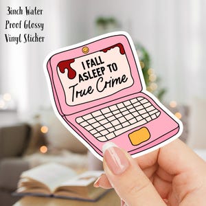 May include: A pink laptop sticker with the text "I fall asleep to true crime". The sticker is 3 inches wide and is water-proof and glossy.