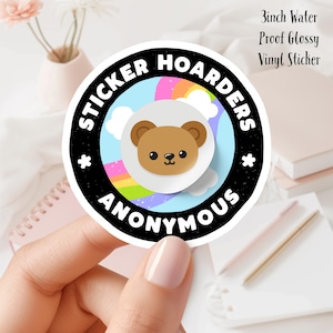May include: A 3 inch water-proof glossy vinyl sticker with a black circle and white text that reads "Sticker Hoarders Anonymous". Inside the circle is a rainbow, clouds, and a cartoon brown bear with a white background.
