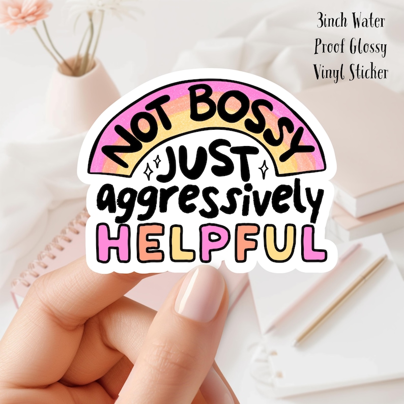 May include: A 3 inch water-proof glossy vinyl sticker with a rainbow design and the text "Not bossy just aggressively helpful".