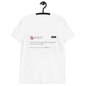 May include: White t-shirt with a printed tweet by John Summit. The tweet says "idc what u think u cannot deny that the gays know how to fkn PARTY." The shirt is displayed on a black hanger.