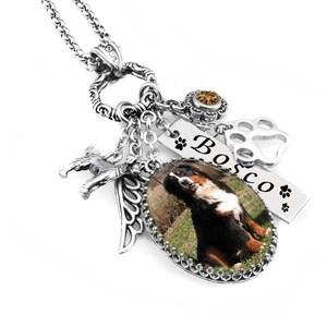 a necklace with a charm that includes a photo of a dog, a paw print, and the name "Bosco".