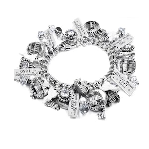 Haunted house charm bracelet with vintage mansion photo charms, ghost charms, engraved tags, pearl ghosts, crystals, and Halloween accents.