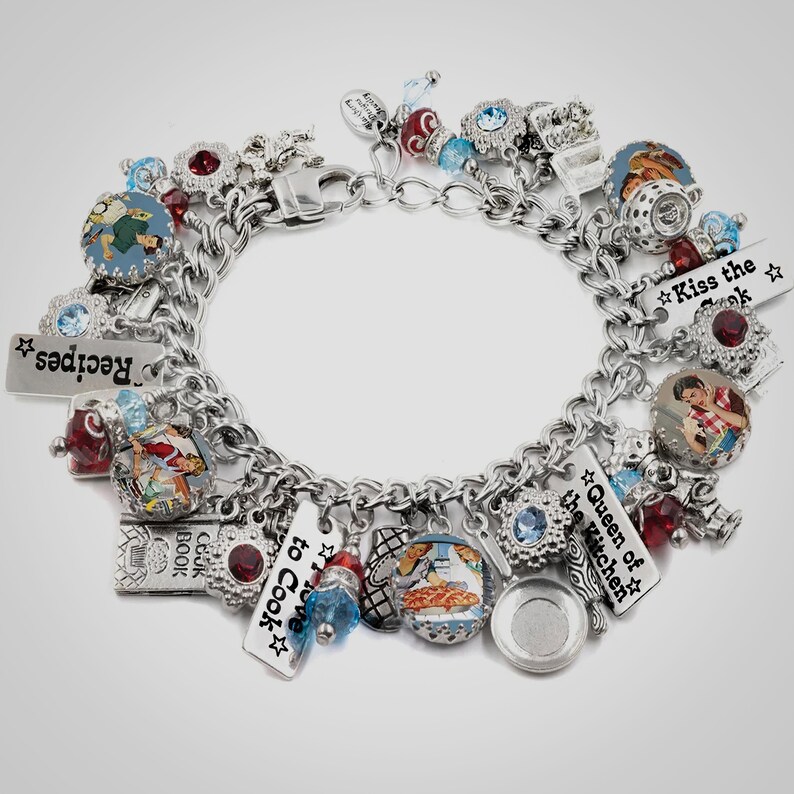 A silver charm bracelet adorned with various charms, including a heart, a book, and a bird, as well as other decorative elements.