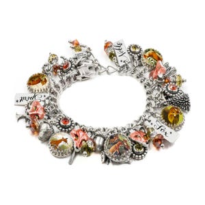 A bracelet adorned with various charms, including a fox charm, and colorful beads.