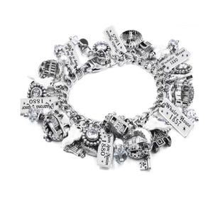 Haunted house charm bracelet with vintage mansion photo charms, ghost charms, engraved tags, pearl ghosts, crystals, and Halloween accents.
