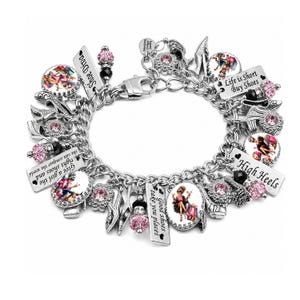 May include: A silver-tone charm bracelet featuring multiple dangling charms, including pink and black beads, high heel shoe charms, and rectangular metal tags with the text "Shoe Diva," "Life is Short Buy Shoes," "High Heels," and "Good shoes take you places."