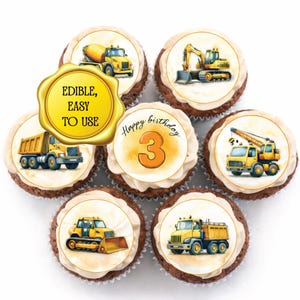 Può includere: Cupcake decorati con immagini commestibili di veicoli da cantiere, tra cui una betoniera, un escavatore e un dumper. Un cupcake ha la scritta "Happy birthday 3". I cupcake sono disposti su una superficie bianca.