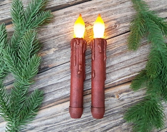 Flameless LED taper candles. Handcrafted with a unique coating. 2 per pack. Magic candle in red.