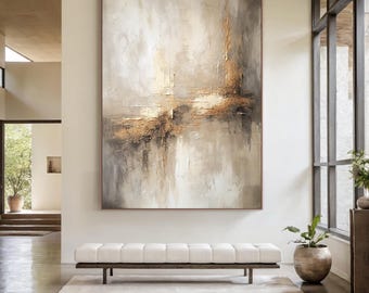 May include: Abstract oil painting in neutral tones of beige, gray, and gold. The artwork features textured brushstrokes and a vertical rectangular format. The painting is displayed in a modern interior setting, above a white bench and a light-colored rug.