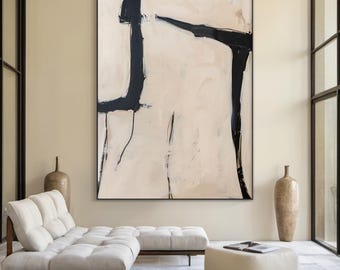 May include: Abstract painting with black lines and shapes on a beige background. The painting is framed and hanging on a wall in a modern living room.