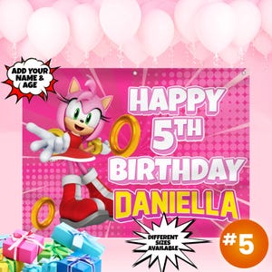May include: Pink and yellow birthday banner featuring a cartoon character with a pink dress and a gold ring. The banner says "Happy 5th Birthday Daniella" and has a pink and white polka dot background.