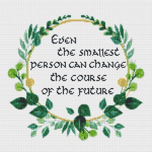 May include: A green floral wreath with a gold circle in the centre. The text inside the circle reads "Even the smallest person can change the course of the future."