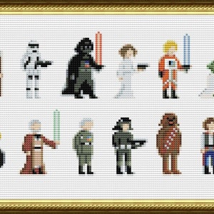 Peut inclure: Un motif de point de croix représentant des personnages de la franchise Star Wars. Les personnages incluent Luke Skywalker, Dark Vador, la princesse Leia, Han Solo, Chewbacca, Yoda, R2-D2, C-3PO, Obi-Wan Kenobi, et plus encore.