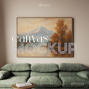 Op de afbeelding: Een ingelijste canvas mockup met een landschapsschilderij met een berg, meer en herfstbomen. De woorden "Canvas Mockup" zijn over de afbeelding geplaatst. Onder het kunstwerk staan een groene bank en een kleine houten tafel.
