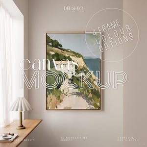 Op de afbeelding: Een ingelijste canvas mockup met een landschapsschilderij. Het schilderij toont een kustlandschap met groene heuvels, een wit gebouw en blauw water. Het frame heeft een lichte houtkleur. Tekst op de afbeelding bevat "Canvas Mockup" en "4 Frame Colour Options."