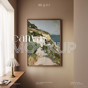 May include: A framed canvas mockup with a landscape painting, featuring a coastal scene with a path, cliffs, and sea. The text "canvas MOCKUP" is overlaid on the image. A lamp and small objects sit on a wooden ledge. The image also includes the text "4K RESOLUTION 300DPI".