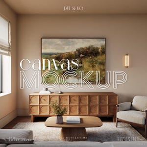 May include: A living room mockup featuring a wooden cabinet, coffee table, and armchair. A framed landscape painting hangs above the cabinet. The words "canvas MOCKUP" are displayed in large white letters. The room has a neutral color palette.