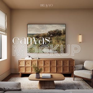 May include: A canvas mockup featuring a landscape painting in a wooden frame, hanging above a wooden cabinet with a decorative pattern. The cabinet is in a living room setting with a coffee table, a rug, and a chair.