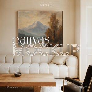 May include: A canvas mockup featuring a framed landscape painting above a cream-colored sofa. The text "canvas mockup" is overlaid on the image. A wooden coffee table and a black leather chair are in the foreground. The image has a neutral color palette.
