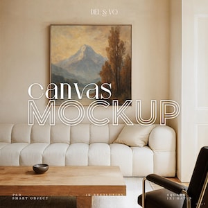 Puede incluir: Una maqueta de lienzo con una pintura de paisaje enmarcada sobre un sofá crema. Las palabras "canvas mockup" se muestran en letras grandes, blancas y delineadas. Una mesa de centro de madera y una silla de cuero negro están en primer plano.