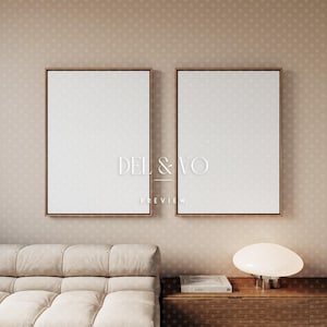 May include: Two framed blank canvases with wooden frames hang on a beige polka-dot wall. The text "DEL & VO PREVIEW" is visible on the canvases. A beige sofa and a wooden cabinet with a lamp are in the foreground.