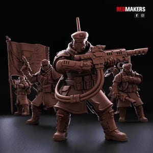 May include: A set of four brown miniature soldier figurines in tactical gear, including berets, gas masks, and heavy rifles. One soldier holds a large flag with a skull emblem. The text REDMAKERS is visible in the top right corner of the image.
