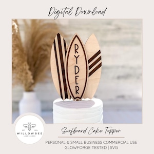 May include: A wooden surfboard cake topper with the name "RYDER" engraved on the center surfboard. The topper is designed for a cake and features three surfboards with a striped pattern.