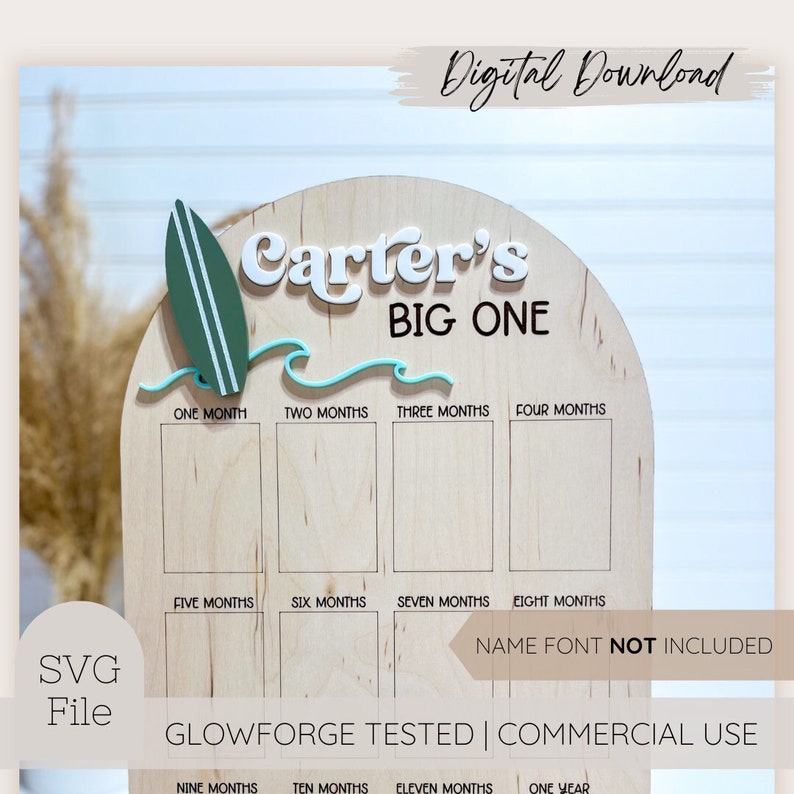 May include: A wooden milestone board with the text "Carter's BIG ONE". It features a green surfboard and blue waves. The board has spaces for monthly photos and the text "Digital Download" and "SVG File".