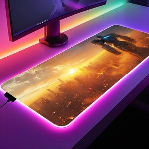 May include: A large, rectangular gaming mouse pad with a cityscape and sunset background. The mouse pad has a bright pink LED light around the edge. The cityscape is a futuristic city with tall buildings and a bright orange sunset in the background. Two large robots are walking in the foreground.