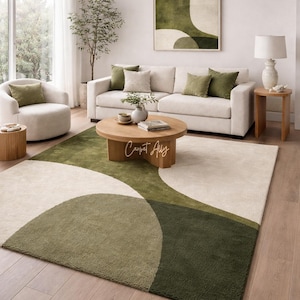 Hand tufted abstract area rug in olive green and ivory with organic curved design placed in a modern living room. Soft textured rug with nature inspired pattern and neutral tones, ideal for contemporary home décor, minimalist interiors, and living room styling.