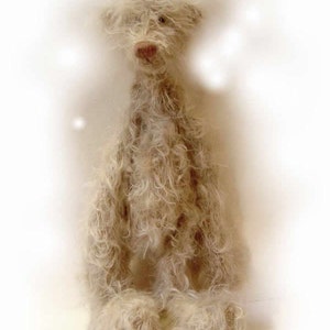 May include: A white, fluffy teddy bear with a long neck and a brown nose. The bear is sitting with its legs crossed and its arms at its sides.