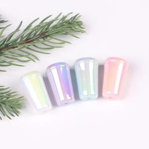 May include: Four iridescent pastel-colored plastic cups with a glossy finish. The cups are arranged in a row from left to right: light blue, purple, light blue, and pink.