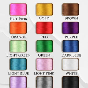 May include: Image showcasing thread color options, including hot pink, gold, brown, orange, red, purple, light green, green, dark blue, light blue, light pink, white, light purple, silver, and black. Text at the top reads "Thread Color Options."