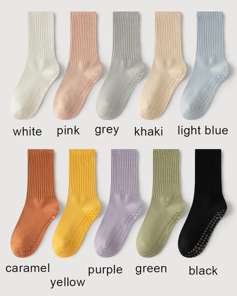 May include: A collection of ten pairs of socks in various colors, including white, pink, grey, khaki, and light blue. The socks have ribbed cuffs and dotted grips on the soles. Additional colors are caramel, yellow, purple, green, and black. The names of the colors are printed below each pair.