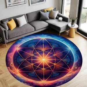 May include: A round, colorful rug with a geometric design in shades of blue, purple, orange, and yellow. The design features a large, intricate starburst pattern with a central sun-like shape.