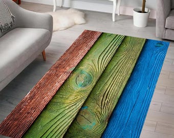 May include: A colorful rug with a wood plank design. The rug features alternating stripes of brown, green, and blue.