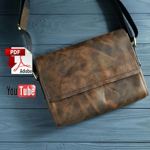 May include: A brown leather messenger bag with a flap closure and a strap. The bag has a distressed look and is made of high-quality leather.
