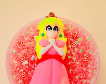 5oz Royal peach crisp, bingsu slime, scented peach, pearlite pigment. Comes with charm