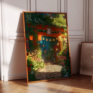 May include: A framed art print depicting a Japanese torii gate and pathway, surrounded by lush greenery and flowers. The artwork features warm colors, with lanterns illuminating the path. The print is displayed in a room with a wooden floor.